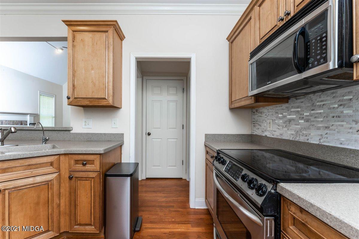 224 Carsons Walk Macon, GA 31206 - Photo 12 of 41 a kitchen with granite countertop a stove top oven microwave and cabinets