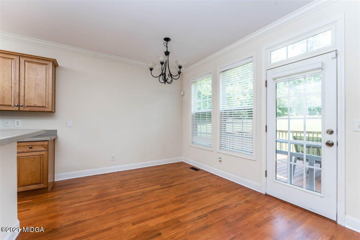 224 Carsons Walk Macon, GA 31206 - Photo 14 of 41 a view of an empty room with wooden floor and a window