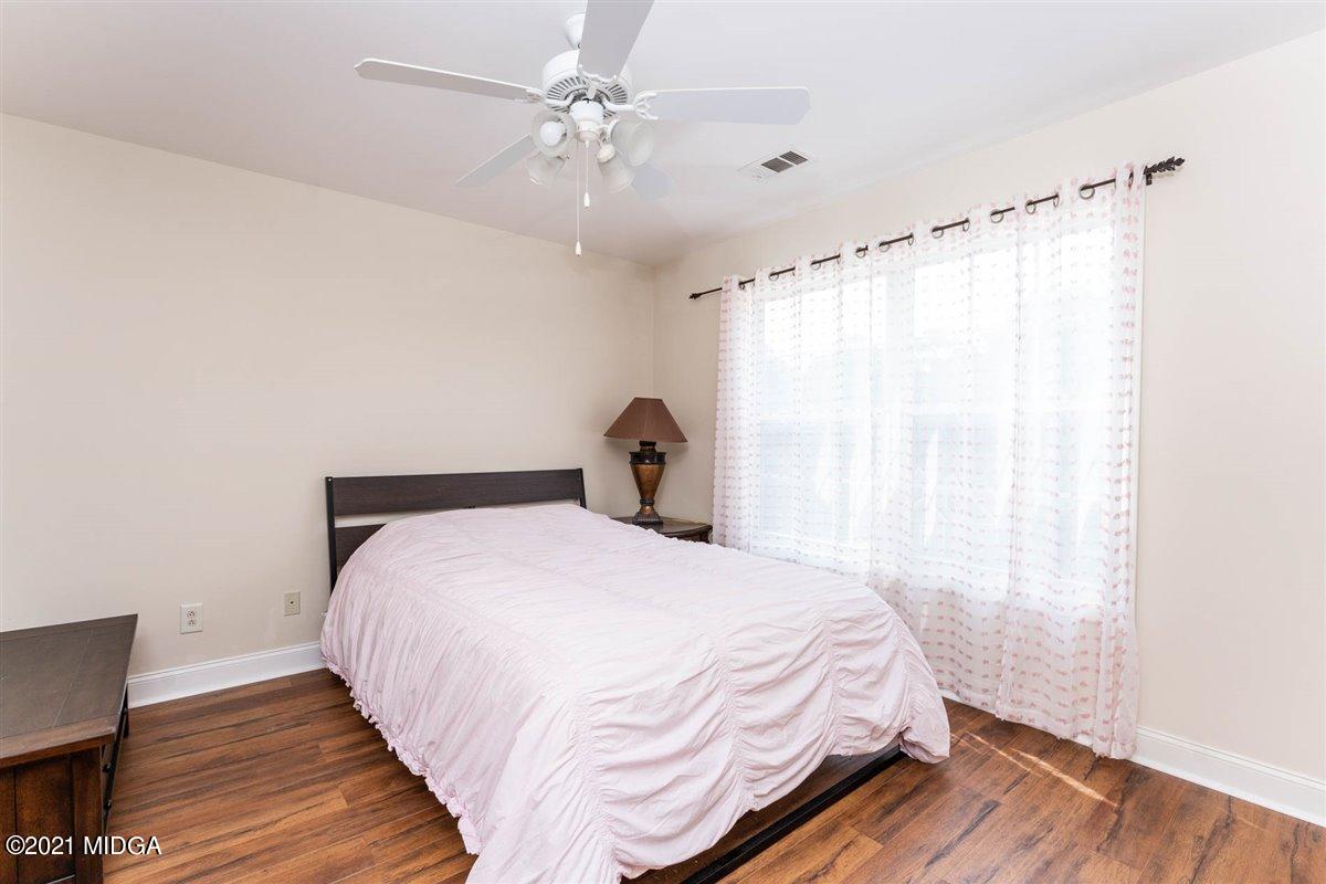 224 Carsons Walk Macon, GA 31206 - Photo 27 of 41 a bedroom with a bed and wooden floor
