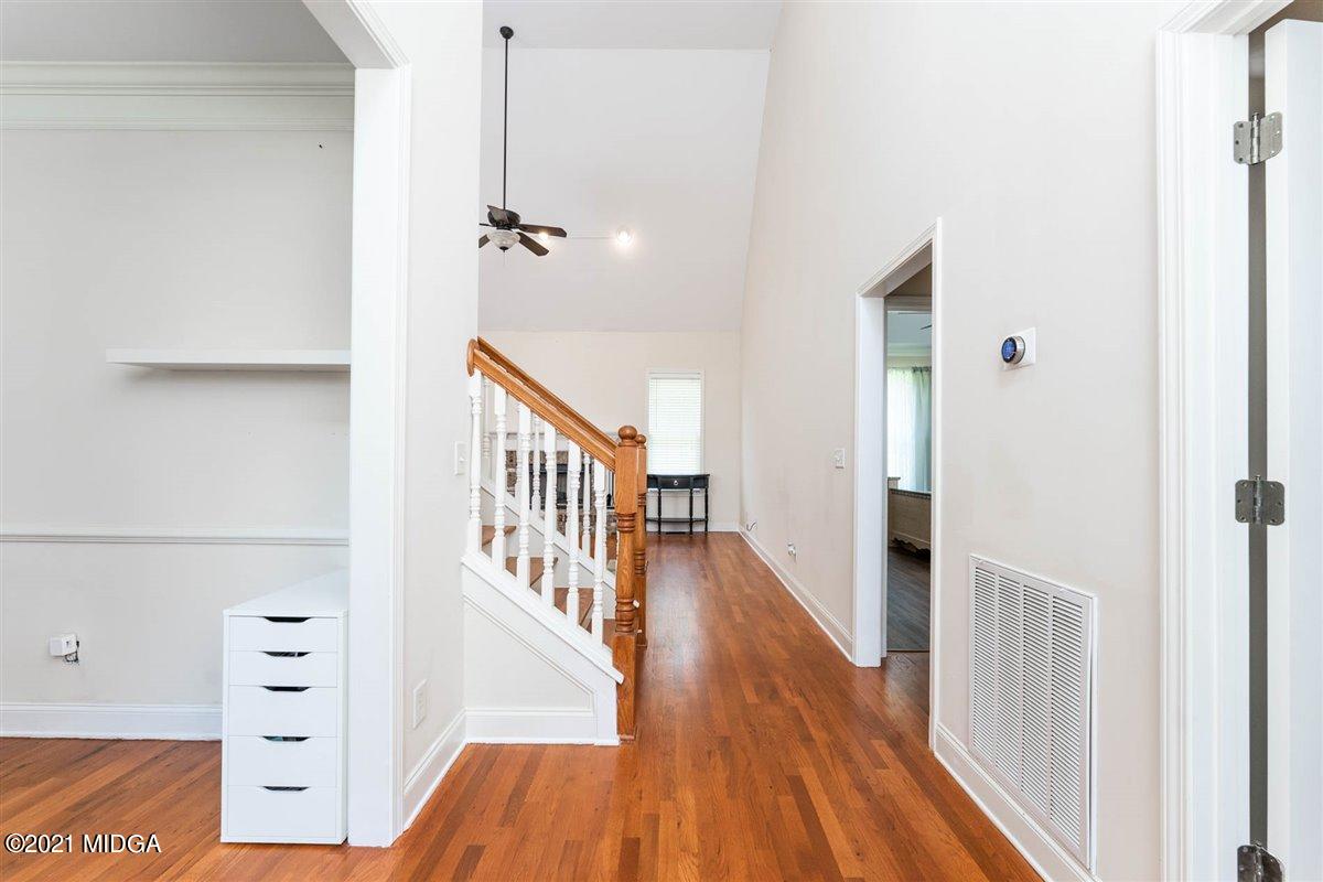 224 Carsons Walk Macon, GA 31206 - Photo 5 of 41 a view of a hallway with wooden floor and staircase