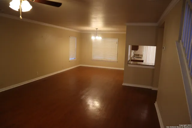 a view of a livingroom with wooden floor and a window