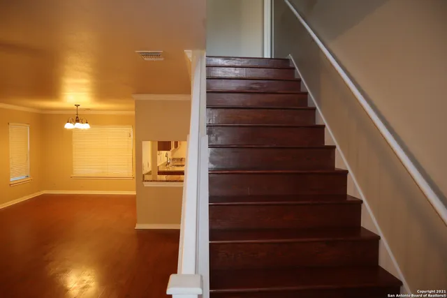 a view of entryway and hall with wooden floor