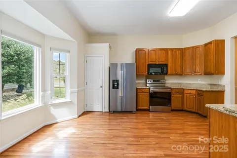 a kitchen with stainless steel appliances a refrigerator and a stove top oven