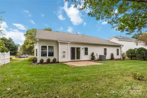 a view of a house with a yard and sitting area