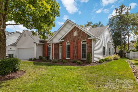 a front view of house with yard and green space