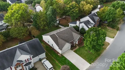 an aerial view of a house with pool outdoor seating and yard