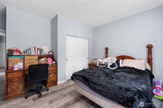 a bedroom with a bed and a chandelier