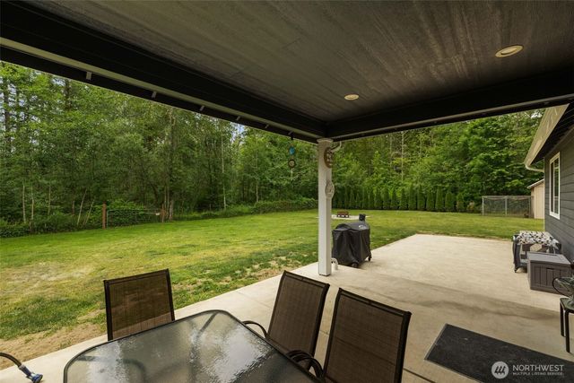 a view of a patio with a yard