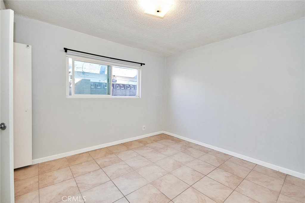 9510 1/2 Beverly Street Bellflower, CA 90706 - Photo 11 of 30 a view of an empty room with windows