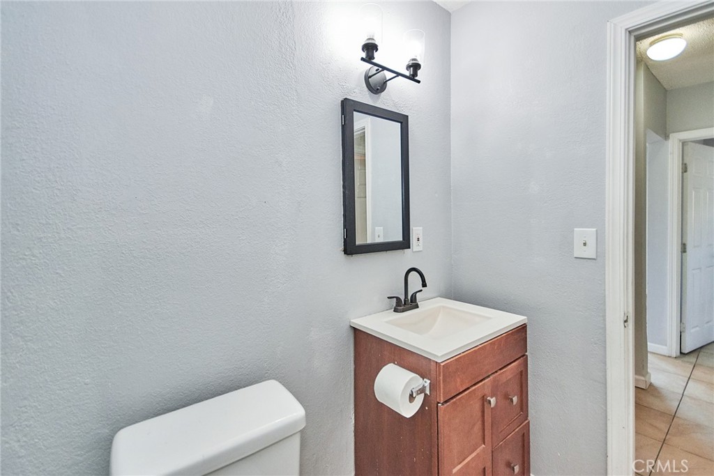 9510 1/2 Beverly Street Bellflower, CA 90706 - Photo 13 of 30 a bathroom with a toilet sink and mirror