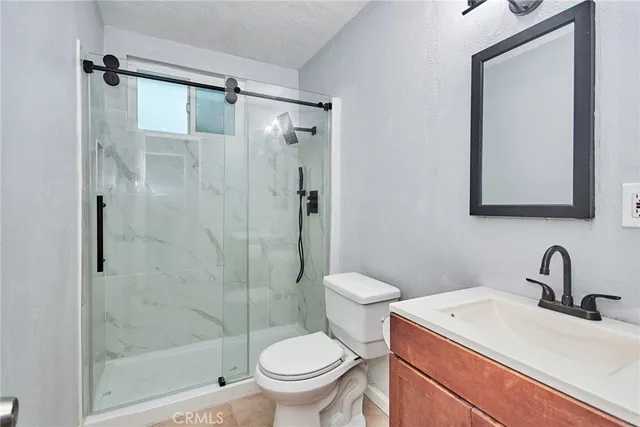 a kitchen with stainless steel appliances granite countertop a stove a sink and a white cabinets