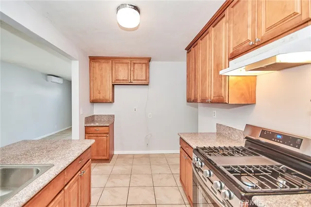 a kitchen that has a sink and a stove