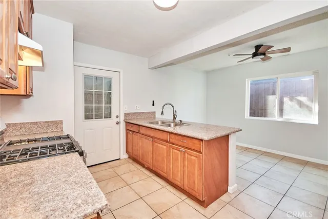 a kitchen with stainless steel appliances granite countertop a sink stove and cabinets