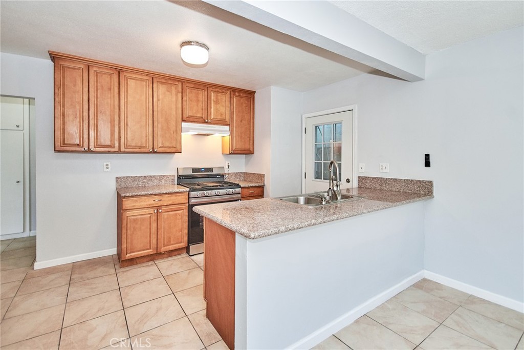 9510 1/2 Beverly Street Bellflower, CA 90706 - Photo 19 of 30 a kitchen with a sink cabinets and window