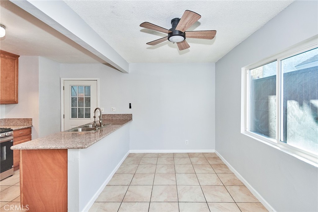 9510 1/2 Beverly Street Bellflower, CA 90706 - Photo 22 of 30 a kitchen with a stove a sink and a window
