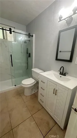 a bathroom with a double vanity sink mirror and toilet
