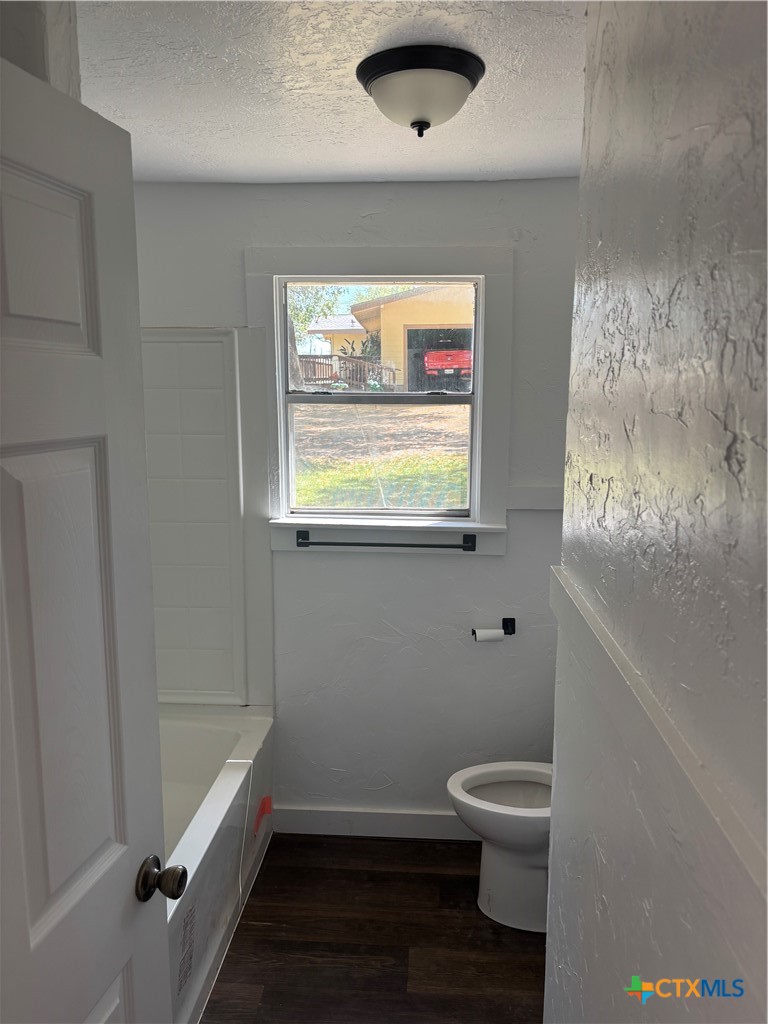 308 Poth Street Yoakum, TX 77995 - Photo 11 of 13 a bathroom with a toilet a sink and tub