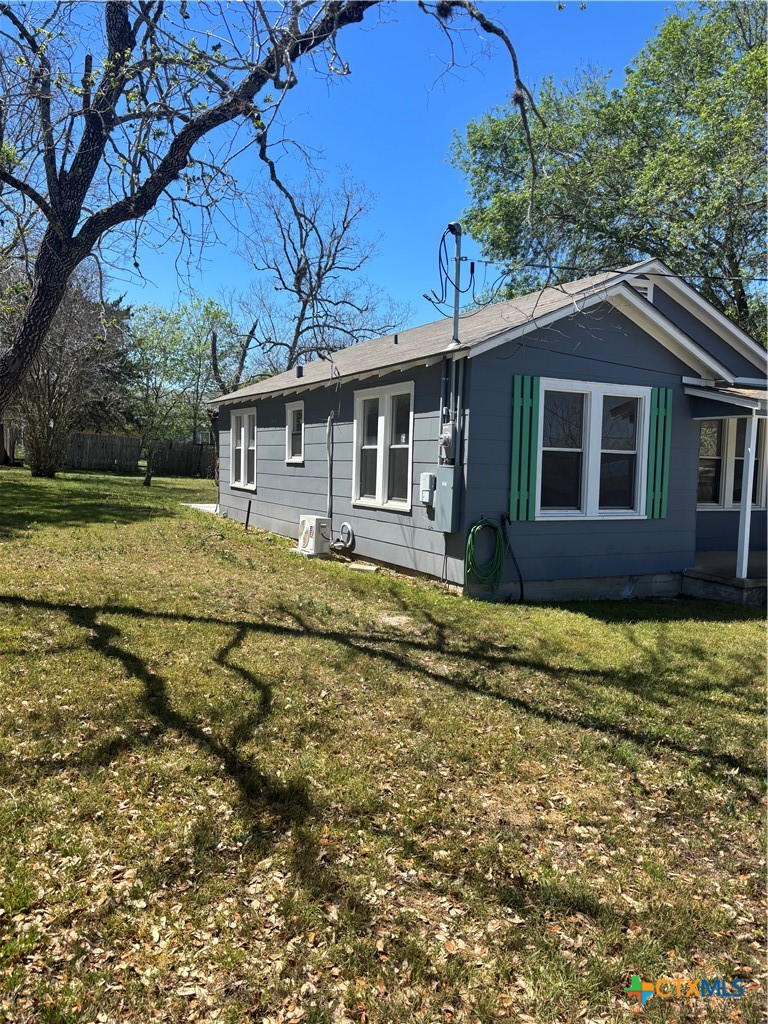 308 Poth Street Yoakum, TX 77995 - Photo 2 of 13 a house with a garden