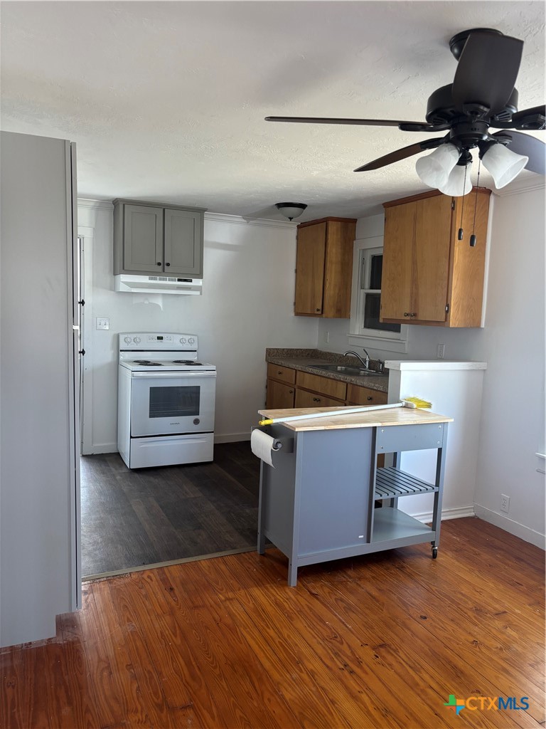 308 Poth Street Yoakum, TX 77995 - Photo 4 of 13 a living room with stainless steel appliances kitchen island granite countertop furniture and a fireplace