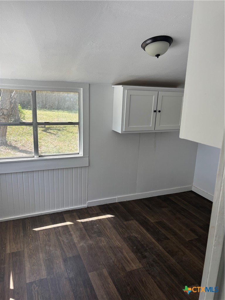 308 Poth Street Yoakum, TX 77995 - Photo 6 of 13 an empty room with wooden floor and windows