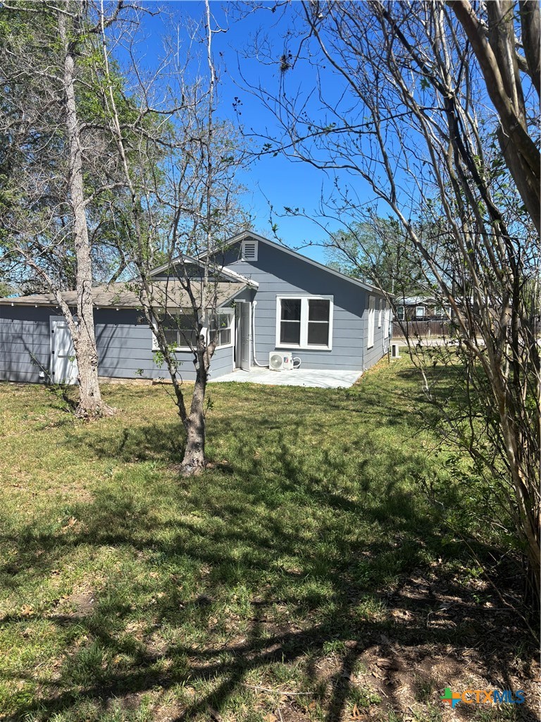 308 Poth Street Yoakum, TX 77995 - Photo 9 of 13 a view of a house with a yard