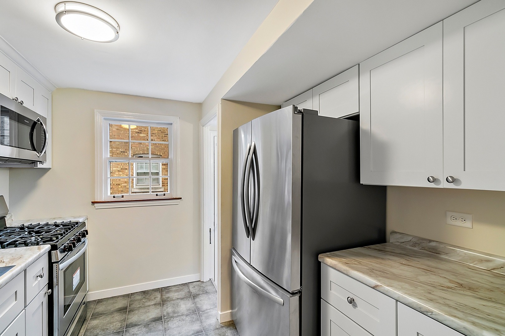 8132 West 26th Street North Riverside, IL 60546 - Photo 5 of 16 a kitchen with stainless steel appliances granite countertop a refrigerator and a stove top oven