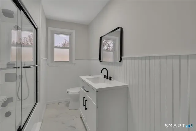 a bathroom with a sink a mirror and shower