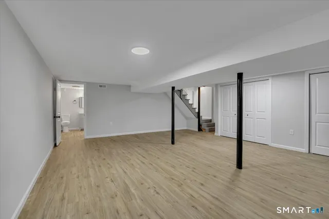 a view of an empty room with wooden floor