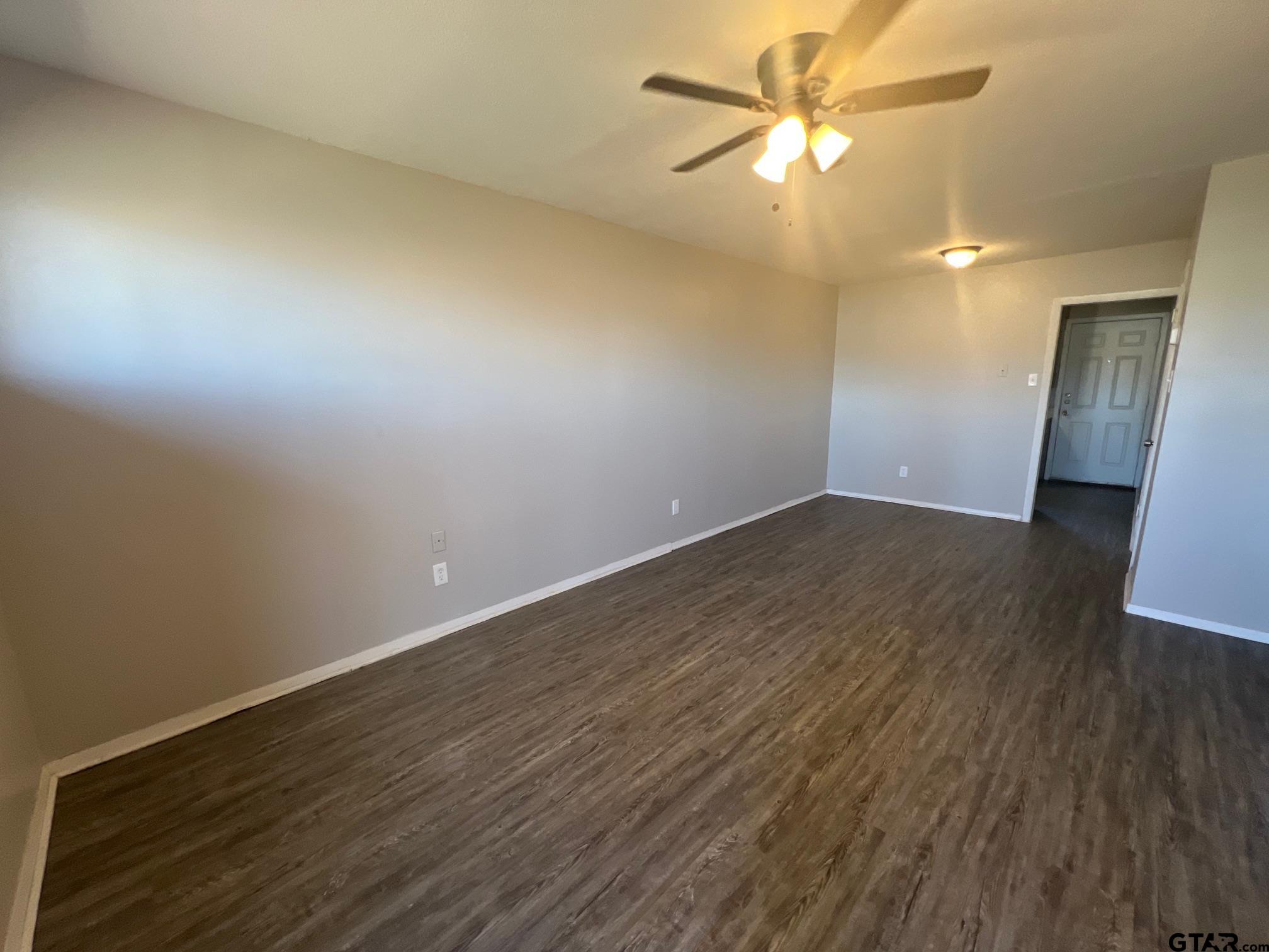 314 South Center Street Longview, TX 75601 - Photo 2 of 8 wooden floor in an empty room