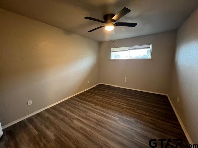 314 South Center Street Longview, TX 75601 - Photo 6 of 8 an empty room with wooden floor fan and windows