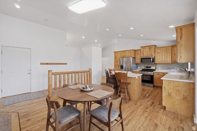 791 East Saddle Road Grantsville, UT 84029 - Photo 13 of 46 Open-concept living space featuring wood-finish flooring, a kitchen with natural wood cabinetry, stainless steel appliances, a kitchen island, and recessed lighting