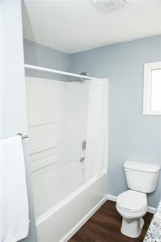 a bathroom with a toilet and a bathtub