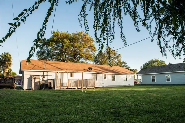 a view of house with backyard