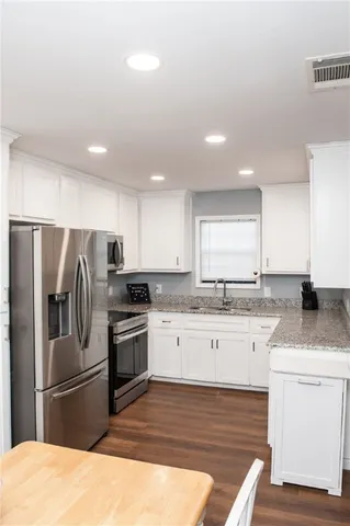 a kitchen with a sink stove and refrigerator