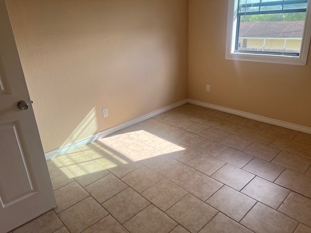 1226 North 5th Street, Unit 3 Kingsville, TX 78363 - Photo 7 of 10 an empty room with windows