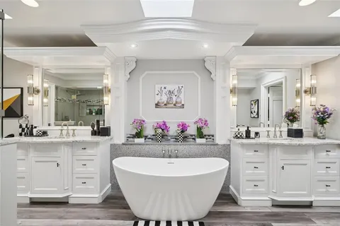 a bathroom with a sink mirror and a bathtub