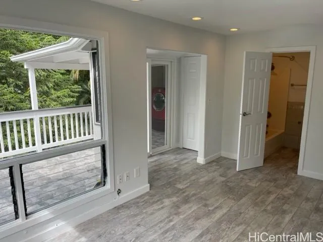 an entryway with wooden floor and windows