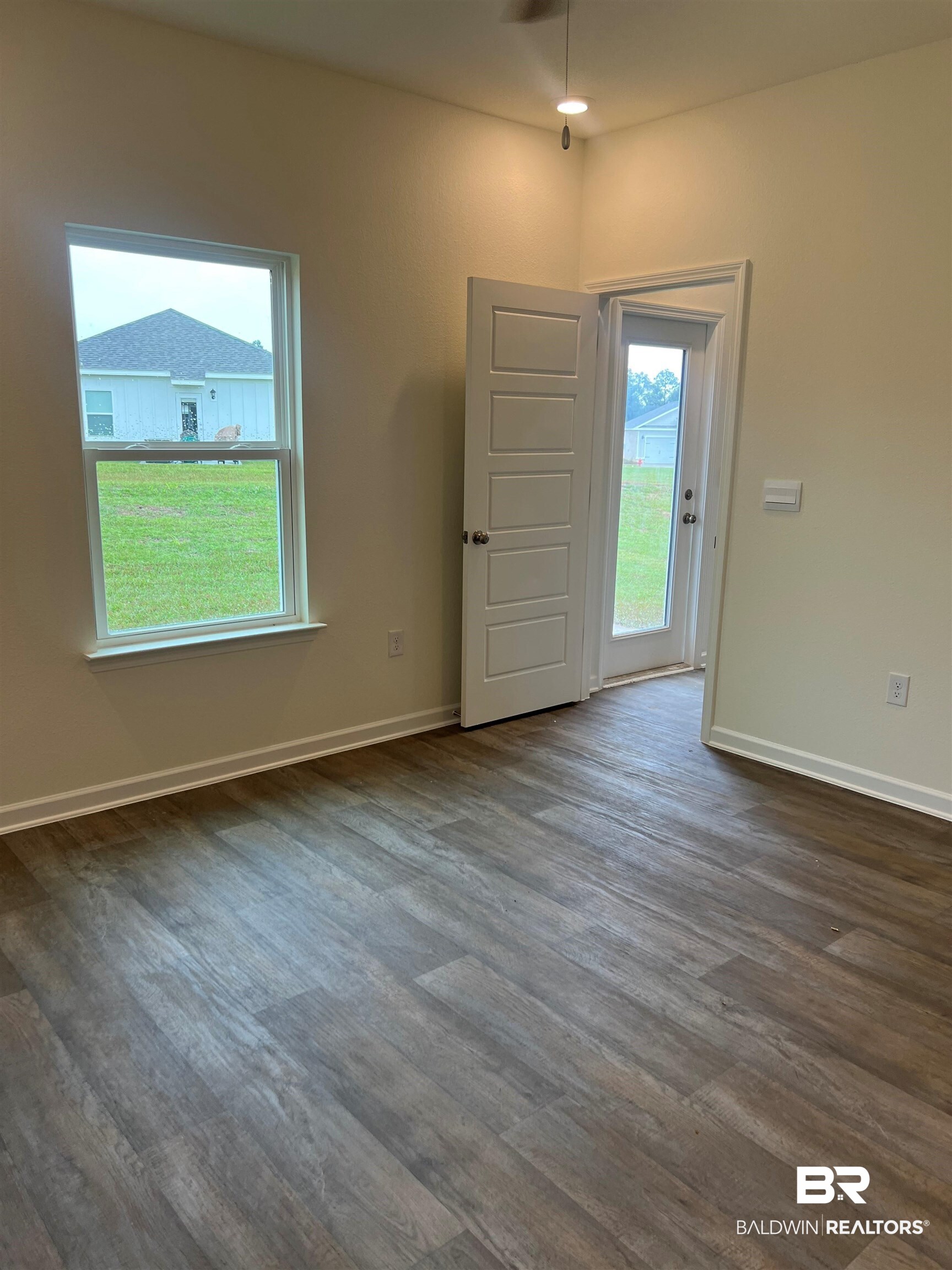 12829 Patriot Way Daphne, AL 36527 - Photo 11 of 38 Entrance foyer with a healthy amount of sunlight and dark hardwood / wood-style floors