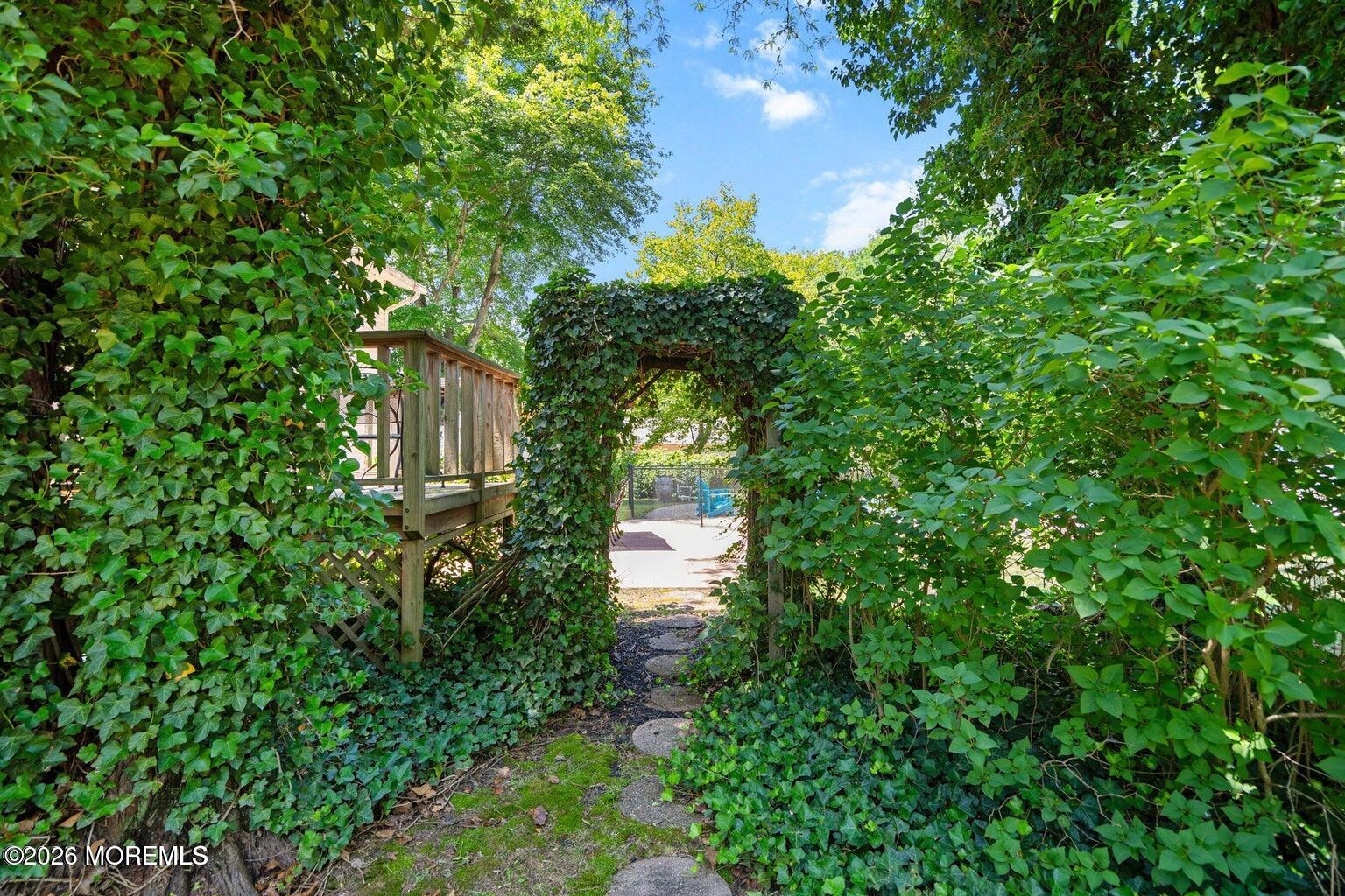 90 East Connecticut Concourse Jackson, NJ 08527 - Photo 14 of 15 a backyard of a house with lots of green space and fountain