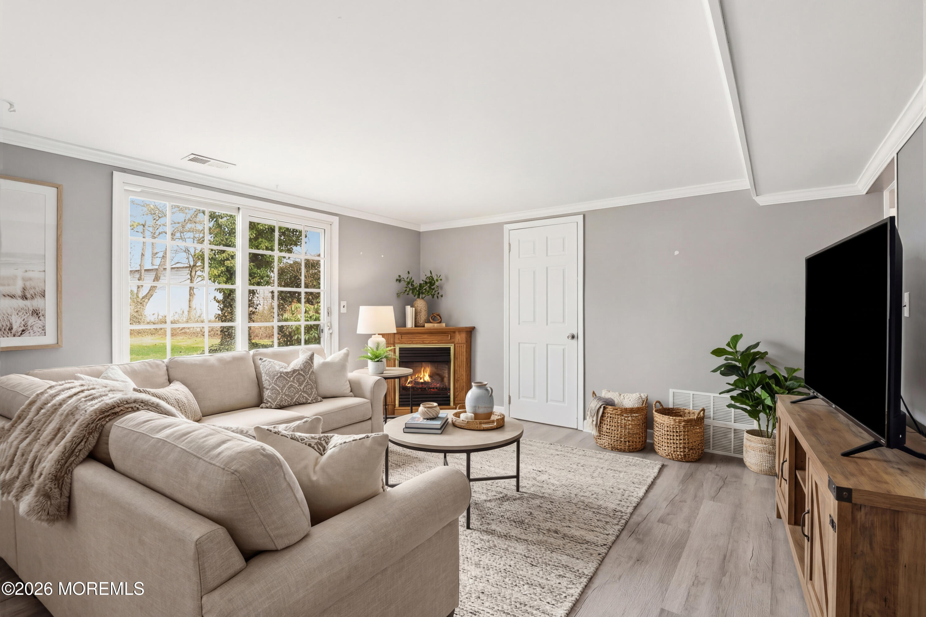 90 East Connecticut Concourse Jackson, NJ 08527 - Photo 4 of 15 a living room with furniture a flat screen tv and a large window