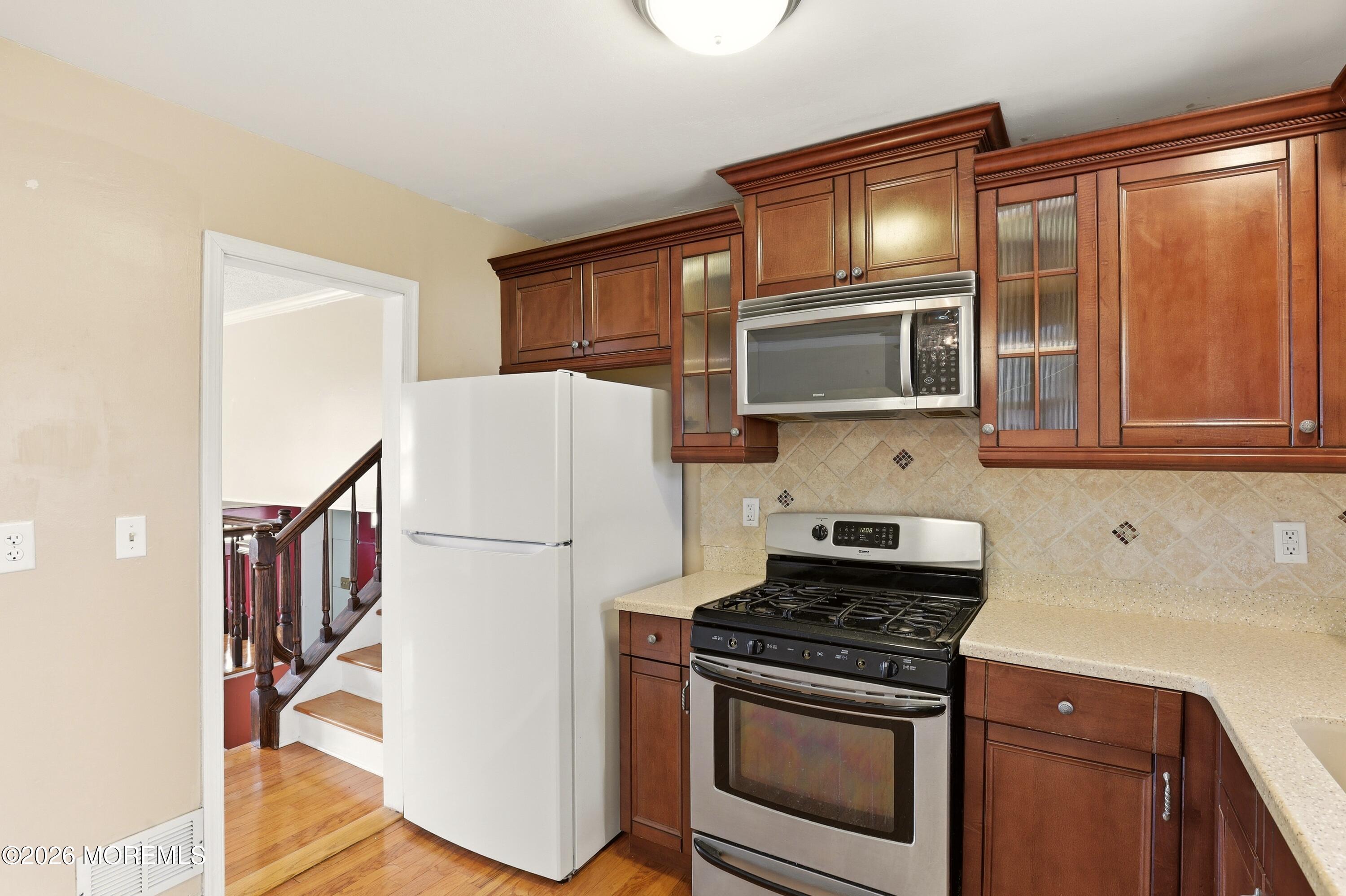 90 East Connecticut Concourse Jackson, NJ 08527 - Photo 7 of 15 a kitchen with a stove microwave and cabinets