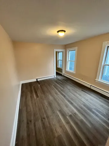 a view of room with window and wooden floor