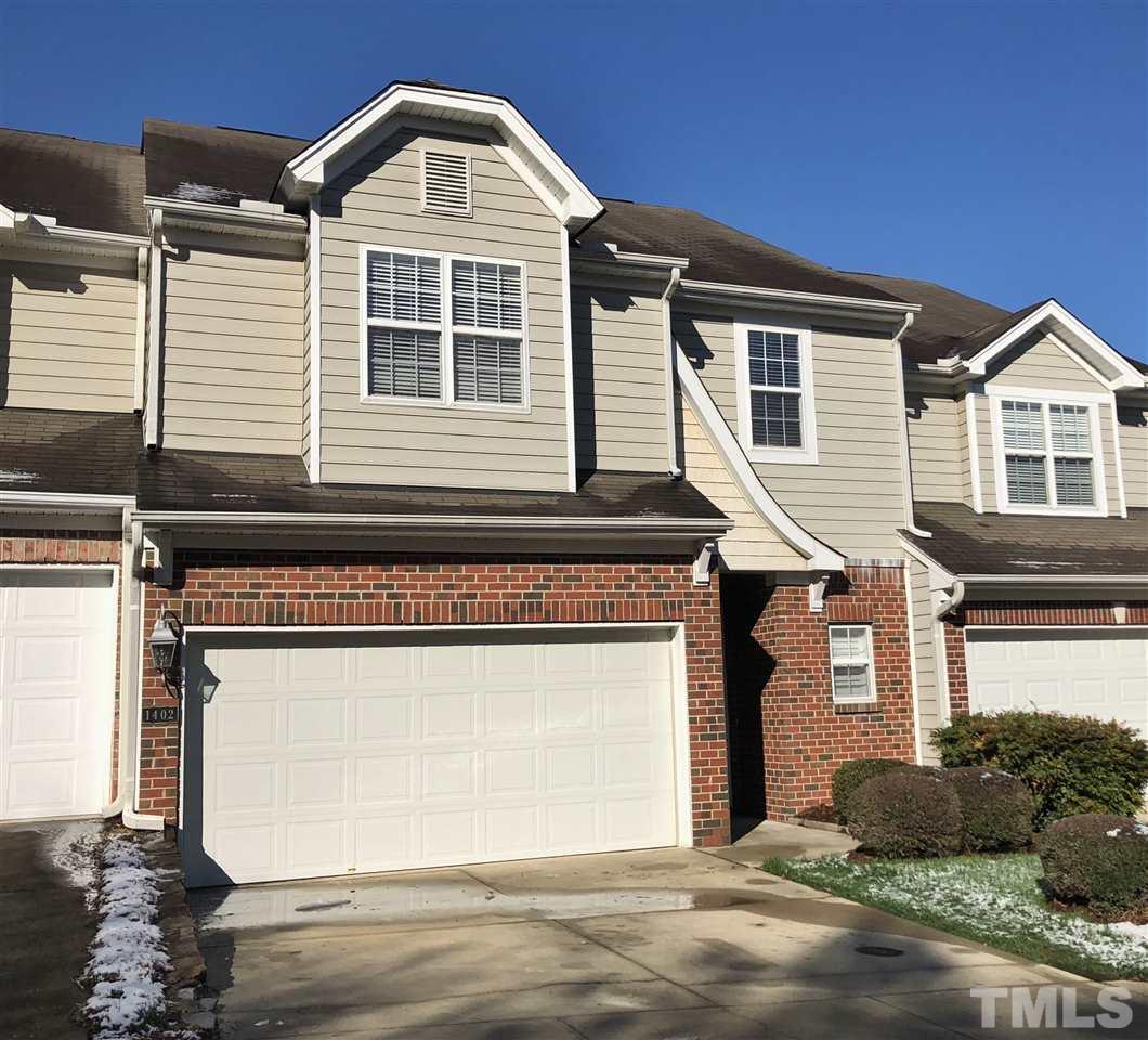 1402 Basinger Court Raleigh, NC 27612 - Photo 1 of 16 a front view of a house with a yard