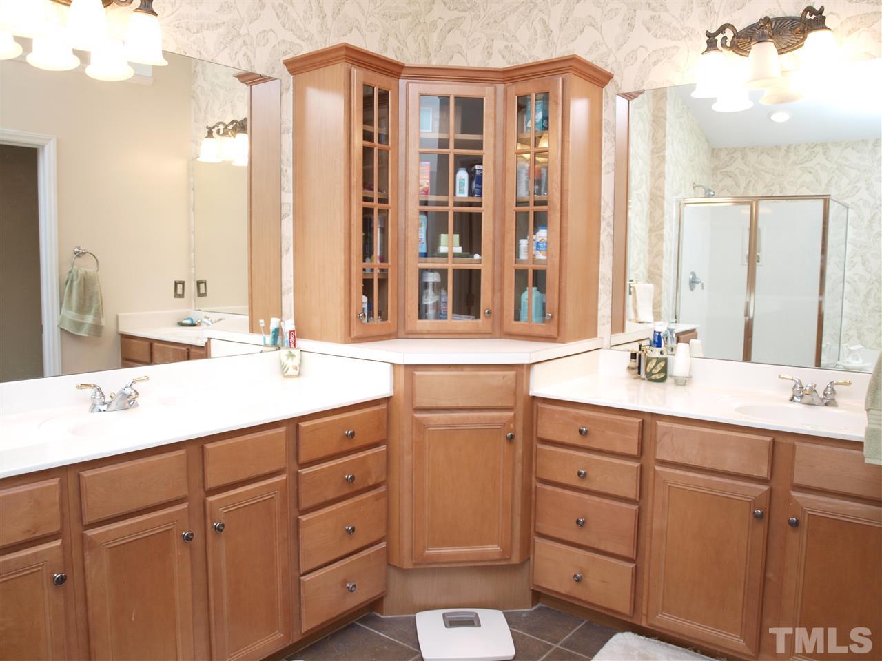1402 Basinger Court Raleigh, NC 27612 - Photo 11 of 16 a bathroom with a double vanity sink a mirror and