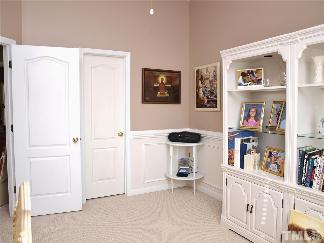 1402 Basinger Court Raleigh, NC 27612 - Photo 13 of 16 a view of room with furniture and book shelf