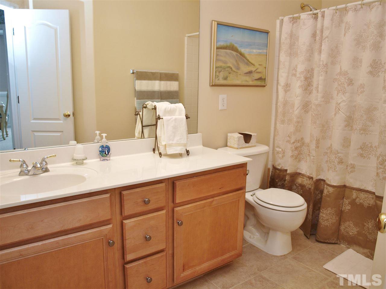 1402 Basinger Court Raleigh, NC 27612 - Photo 14 of 16 a bathroom with a toilet sink and mirror