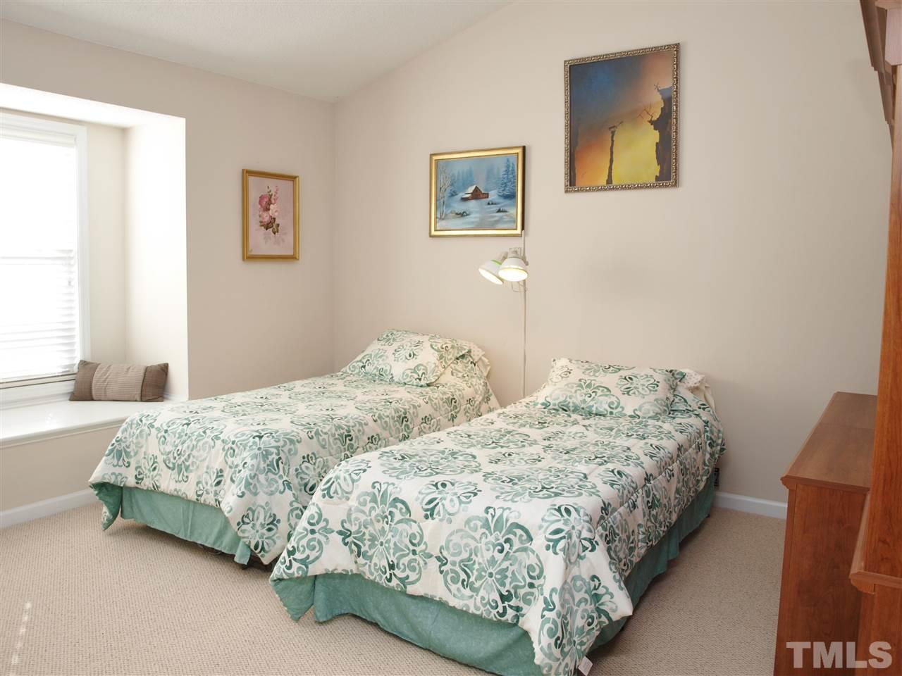1402 Basinger Court Raleigh, NC 27612 - Photo 15 of 16 a bedroom with two beds and painting on the wall