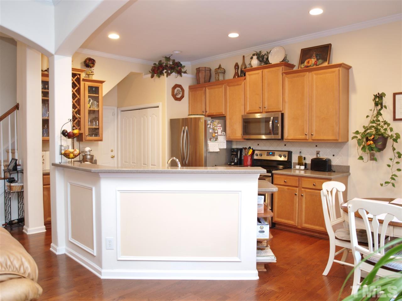 1402 Basinger Court Raleigh, NC 27612 - Photo 6 of 16 a kitchen with a refrigerator and a stove top oven