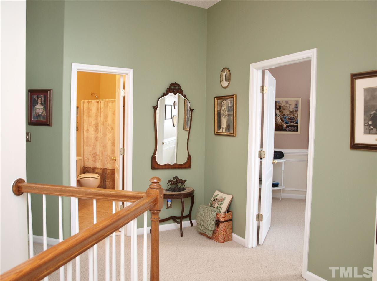 1402 Basinger Court Raleigh, NC 27612 - Photo 8 of 16 a view of a hallway with wooden floor and windows