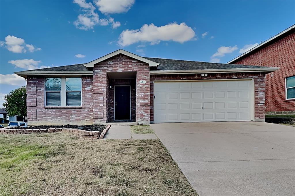 Single story home featuring brick siding, driveway, a front yard, and an attached garage